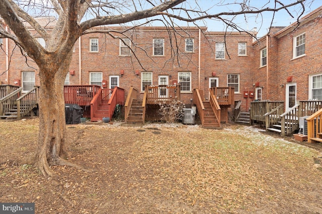 rear view of house featuring central AC and a deck