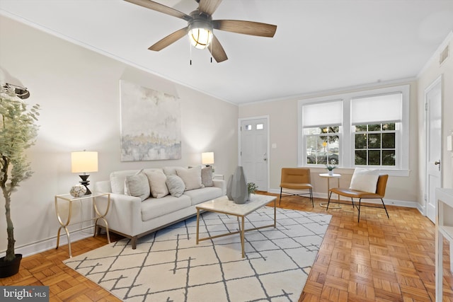 living room featuring crown molding, parquet flooring, and ceiling fan