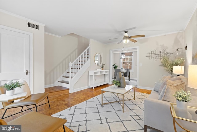 living room featuring ceiling fan, ornamental molding, and light parquet flooring