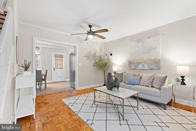 living room featuring ceiling fan, crown molding, and light parquet floors