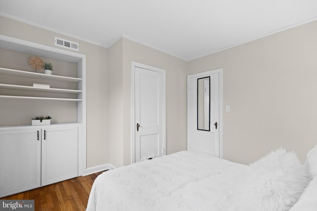 bedroom with ornamental molding and hardwood / wood-style floors