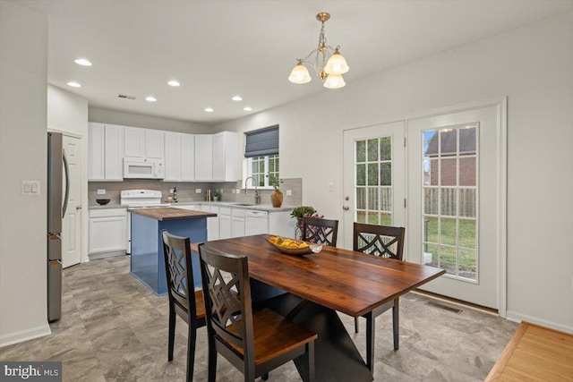 dining room featuring an inviting chandelier and sink