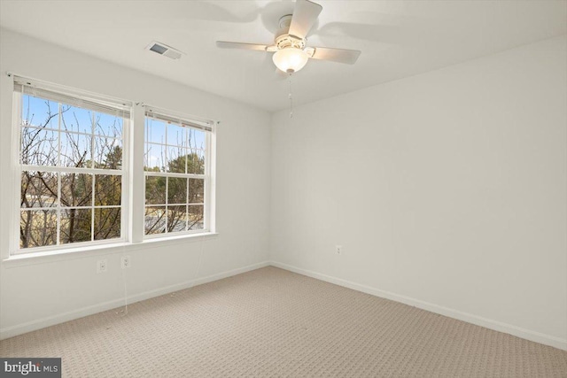 carpeted spare room with ceiling fan