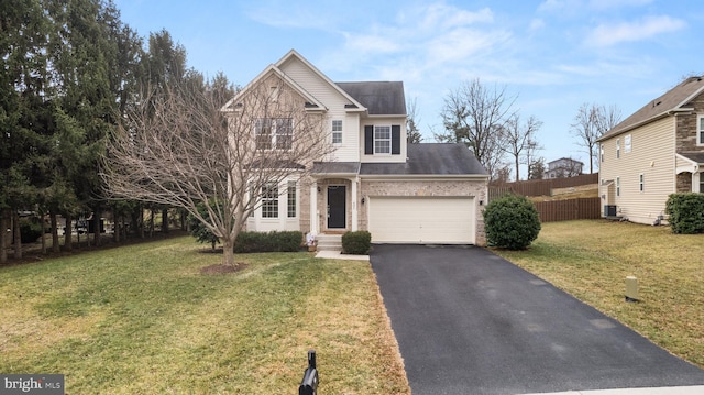 view of front property featuring a garage and a front yard