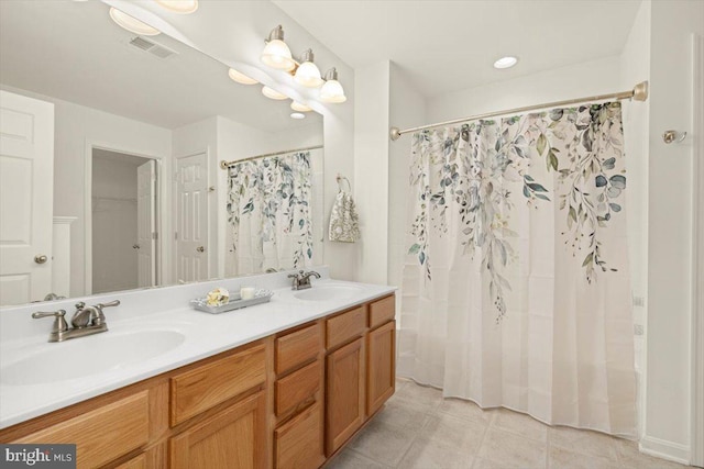 bathroom featuring vanity and curtained shower