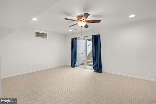 spare room with light carpet and ceiling fan