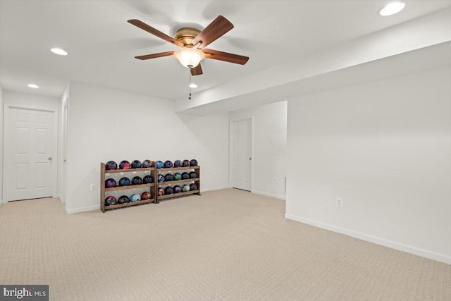 workout room featuring ceiling fan and light carpet