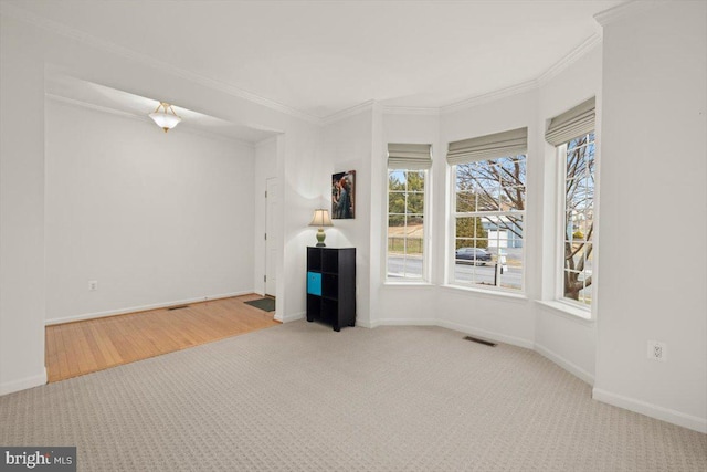 unfurnished living room with crown molding and carpet flooring