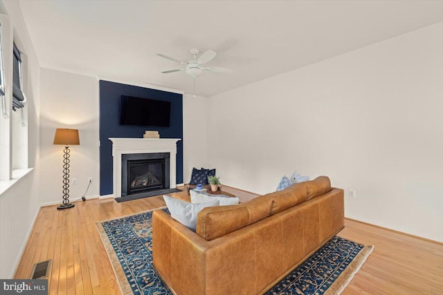 living room with hardwood / wood-style floors and ceiling fan