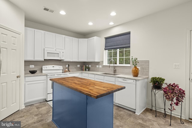 kitchen featuring tasteful backsplash, sink, wooden counters, white cabinets, and white appliances