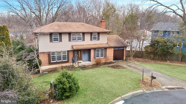 view of front of property featuring a garage and a front lawn