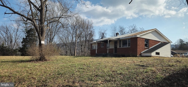 view of side of home featuring a lawn