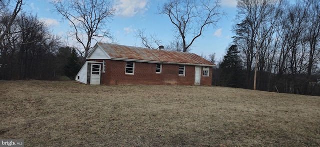 view of side of property with a lawn