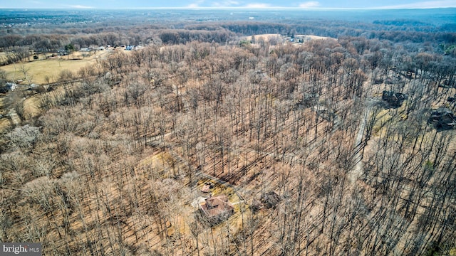 drone / aerial view featuring a forest view