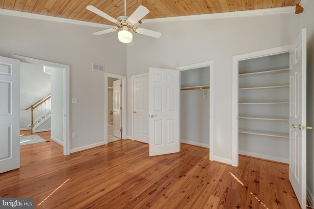 unfurnished bedroom featuring multiple closets, wood ceiling, visible vents, and ornamental molding