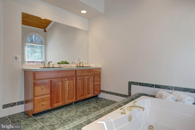 full bathroom featuring double vanity, a tub with jets, a sink, and wood ceiling