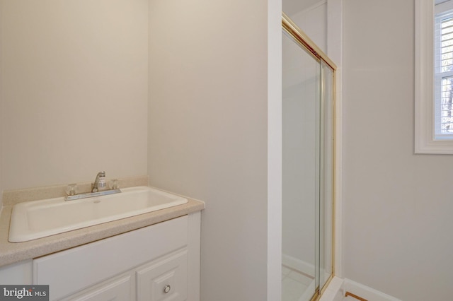 full bath with vanity and a shower with shower door