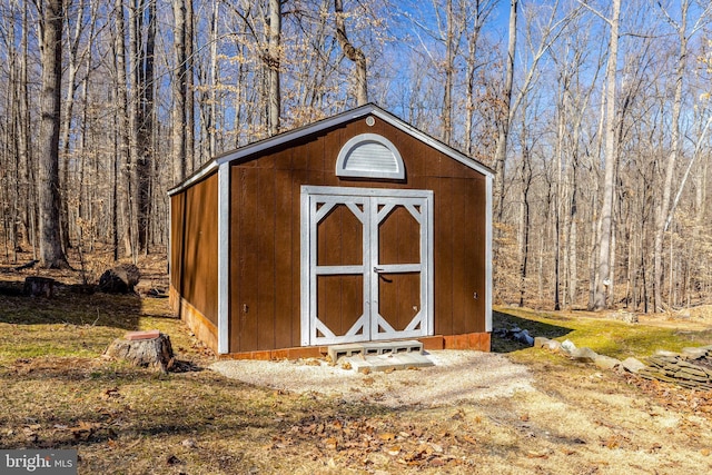 view of shed featuring a wooded view