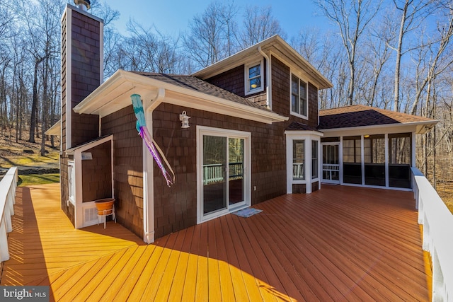 wooden deck featuring a sunroom