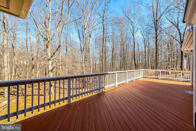 wooden terrace with a view of trees