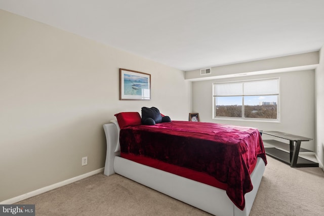 bedroom featuring light carpet