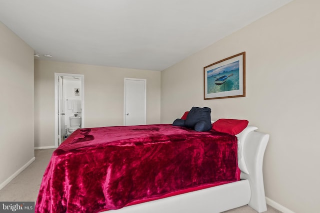 carpeted bedroom featuring connected bathroom