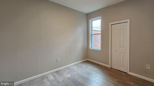 spare room with wood-type flooring