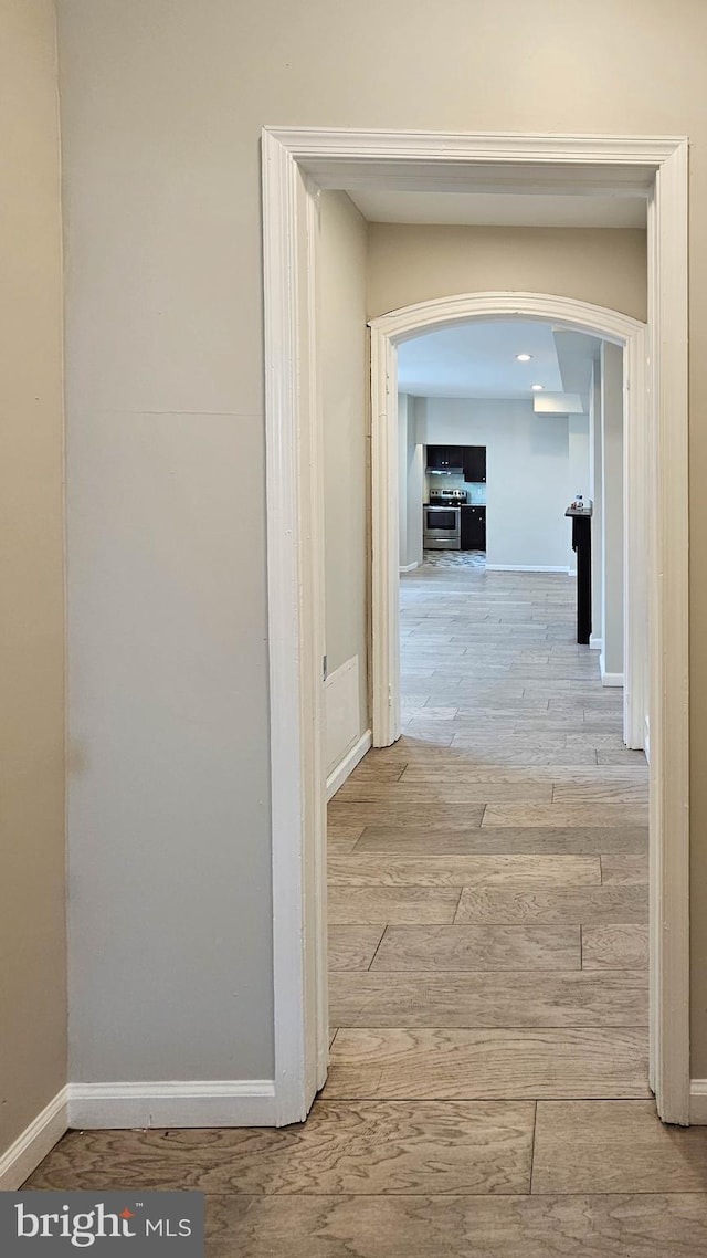 corridor with light hardwood / wood-style floors