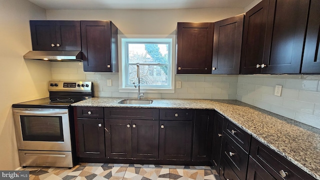 kitchen featuring stainless steel electric stove, light stone countertops, sink, and dark brown cabinets