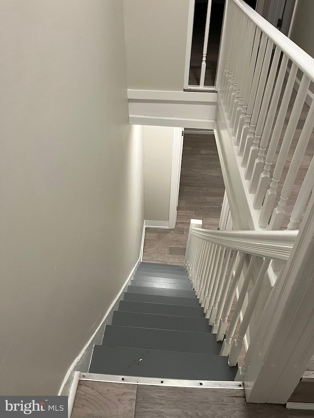 stairway with hardwood / wood-style floors