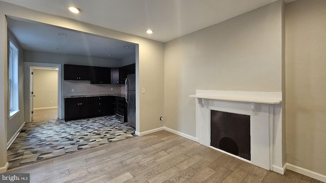 unfurnished living room with light hardwood / wood-style floors