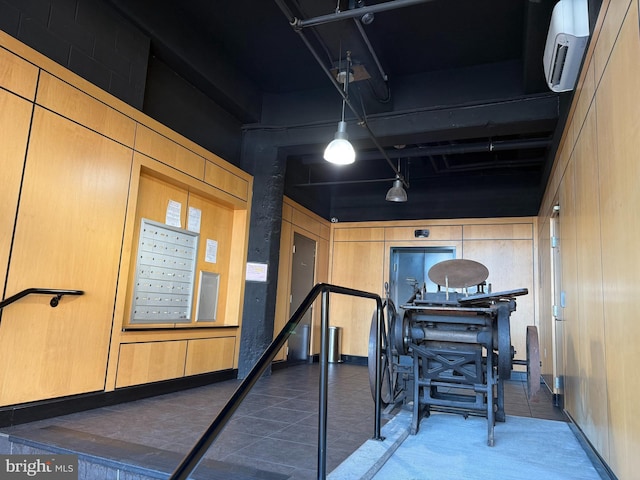 interior space with mail boxes and dark tile patterned floors