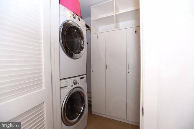 laundry area with stacked washing maching and dryer