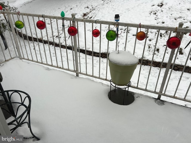 view of snow covered back of property