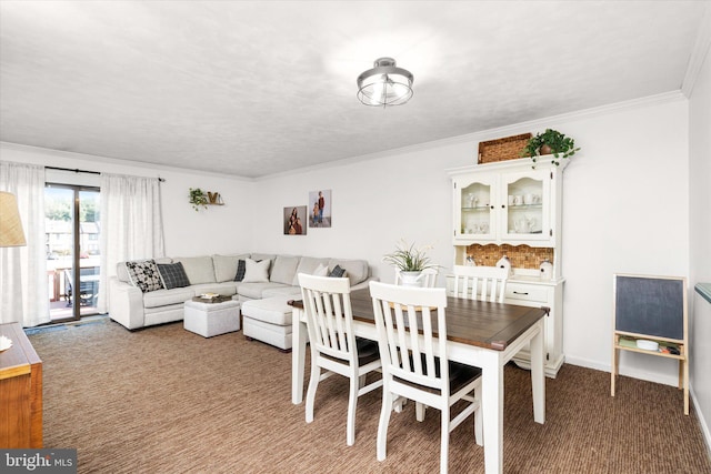 carpeted dining room featuring crown molding