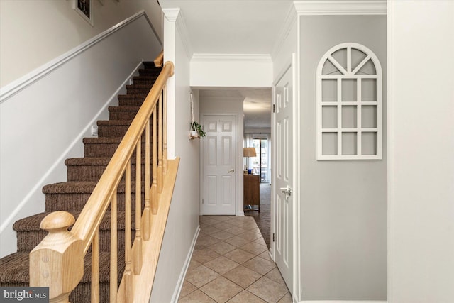 stairs featuring tile patterned flooring and crown molding