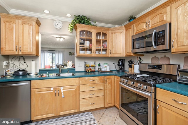 kitchen with light tile patterned floors, sink, crown molding, stainless steel appliances, and decorative backsplash