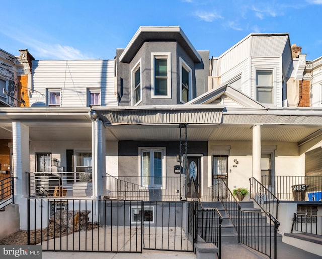 townhome / multi-family property featuring a porch