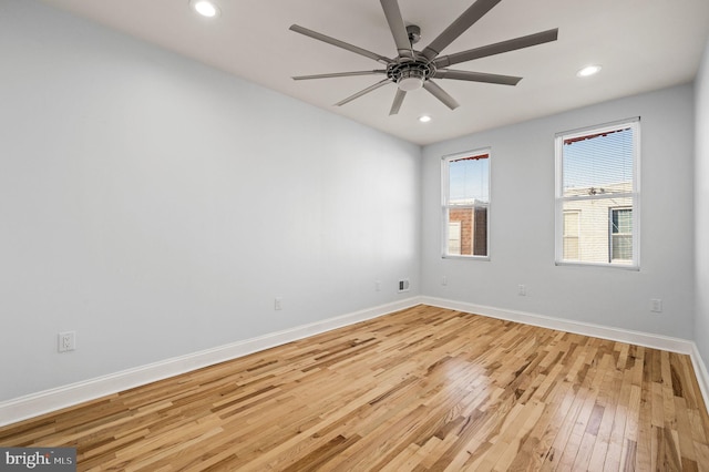 empty room featuring ceiling fan and light hardwood / wood-style floors