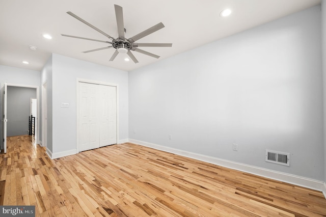 unfurnished bedroom with a closet, ceiling fan, and light hardwood / wood-style flooring