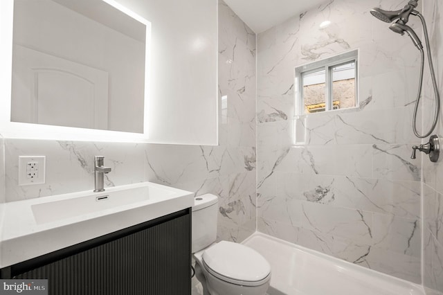 bathroom featuring a tile shower, tile walls, decorative backsplash, vanity, and toilet