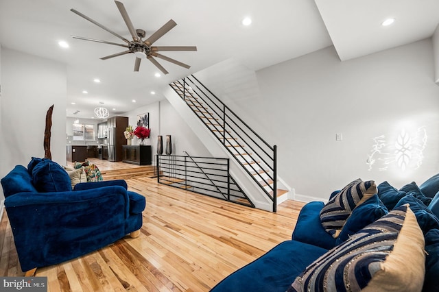 living room with wood-type flooring and ceiling fan