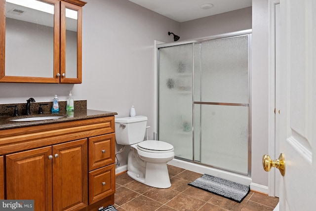 full bath featuring vanity, tile patterned floors, toilet, and a stall shower