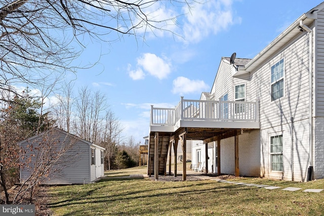 view of side of property with a yard, an outbuilding, a wooden deck, and stairway