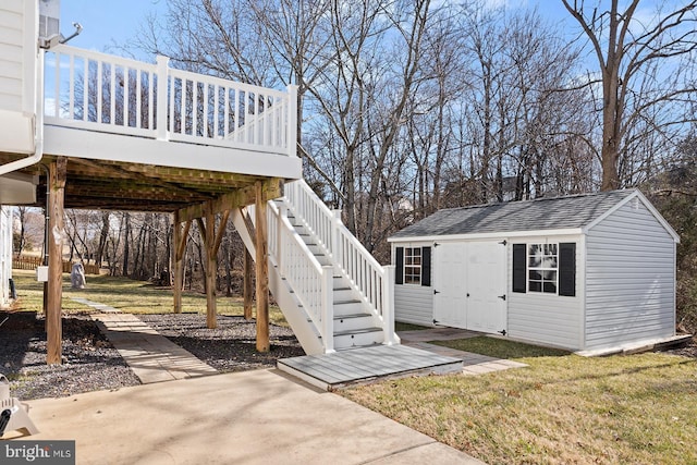 view of yard with a wooden deck, stairway, an outbuilding, and a storage shed