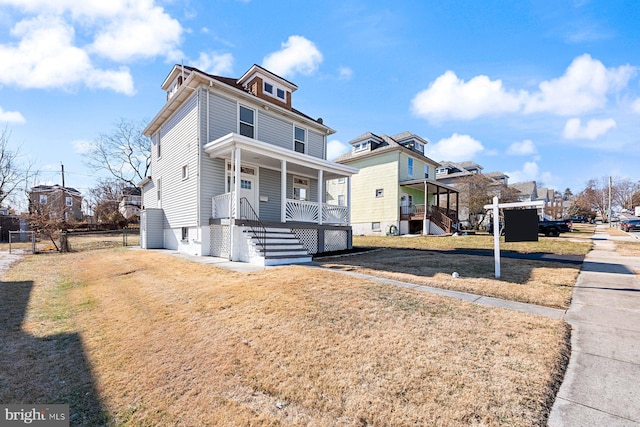 view of front of property with a porch and a front yard