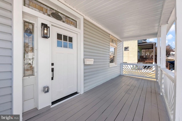 wooden terrace featuring covered porch