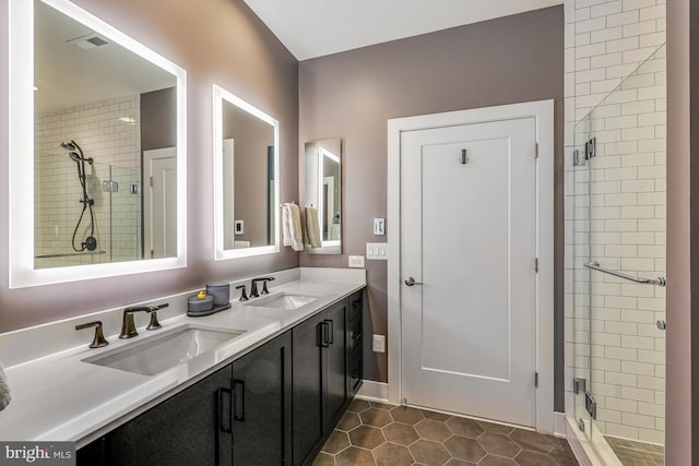 bathroom with vanity, an enclosed shower, and tile patterned floors