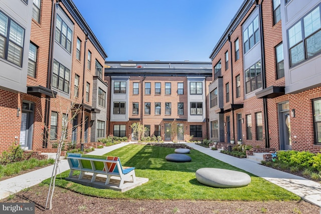 view of property's community featuring a lawn