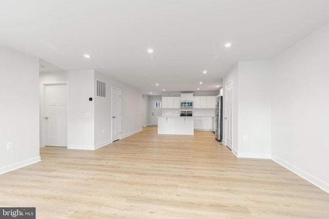 unfurnished living room with light wood-type flooring